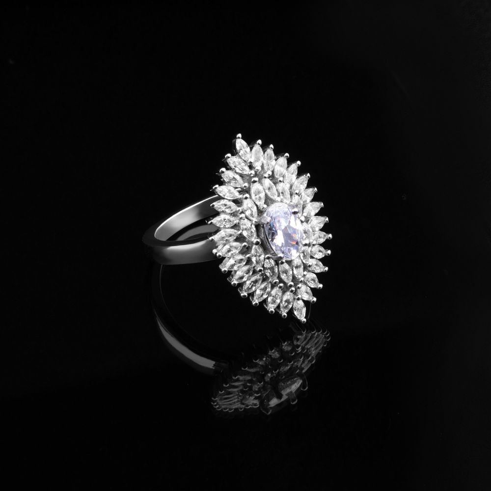Oval diamond surrounded by a double halo of marquise stones in white gold