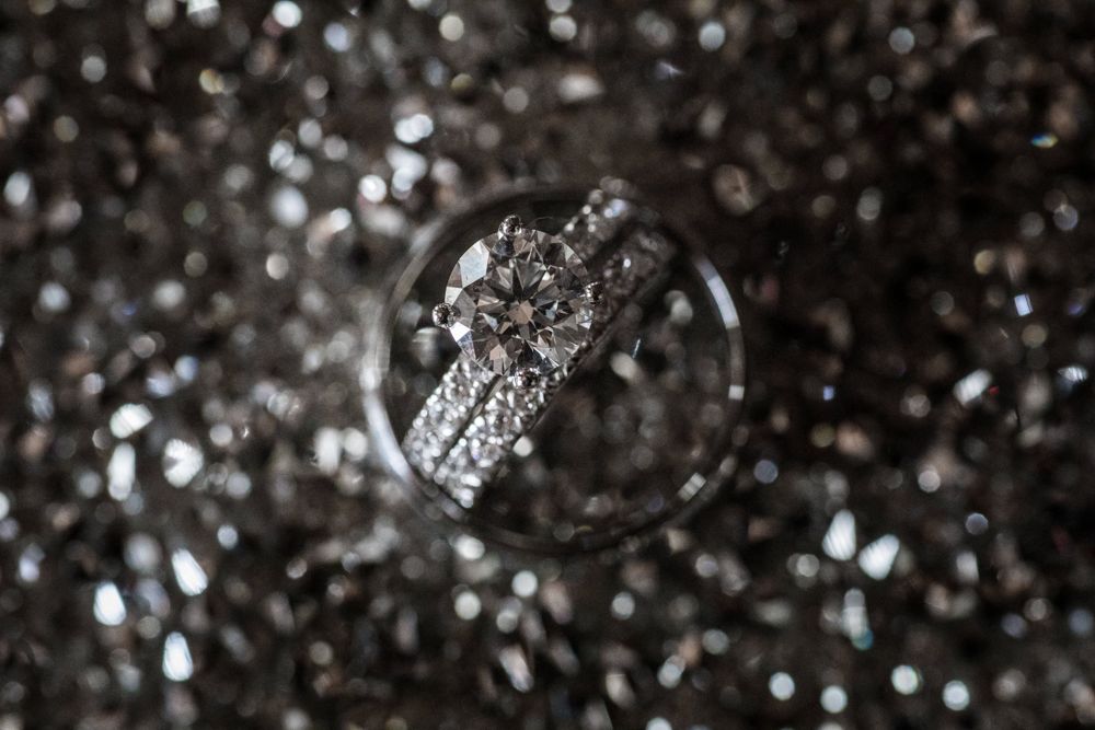 Round diamond solitaire with a matching pavé band on a sparkling background